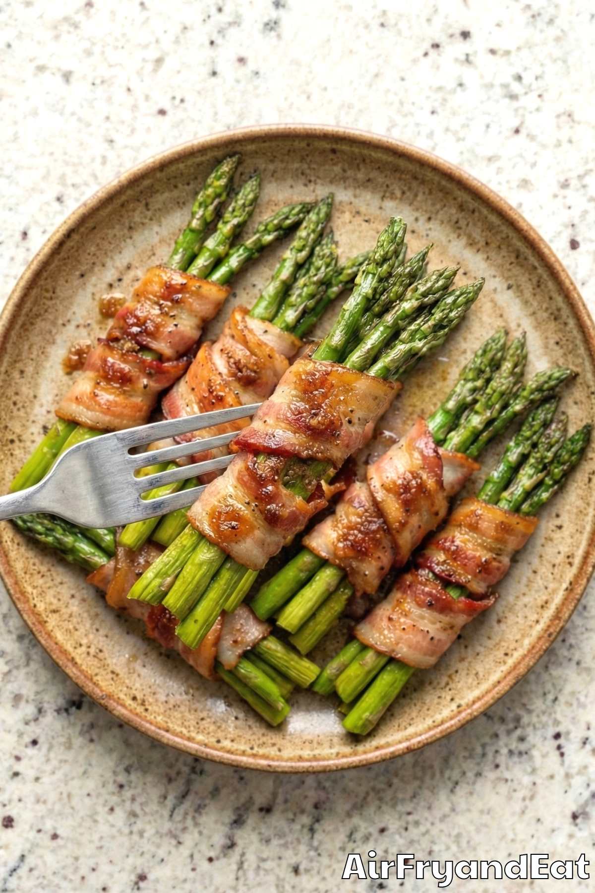 Simple bacon wrapped asparagus bundles plated