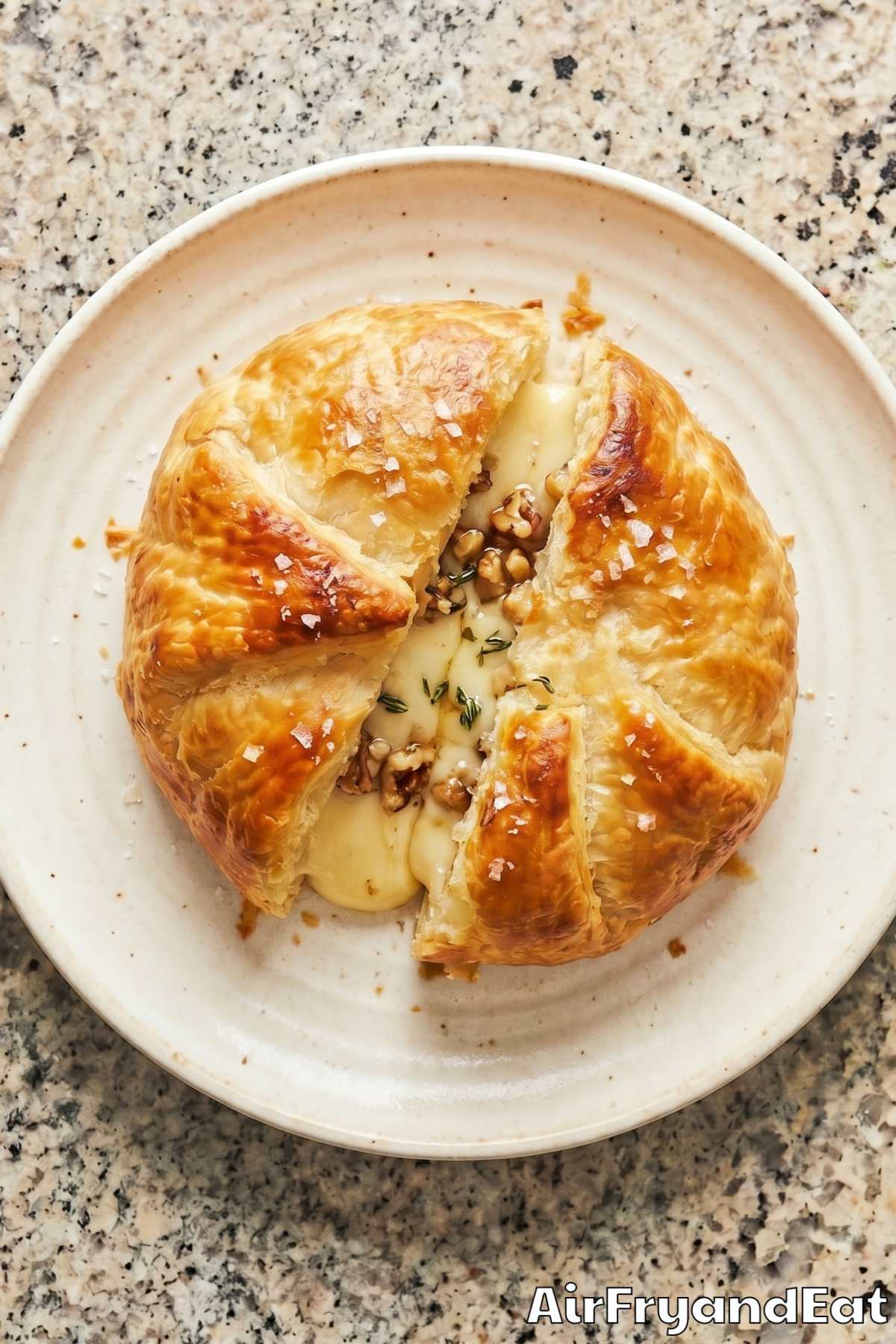 Easy air fryer baked brie oozing cheese