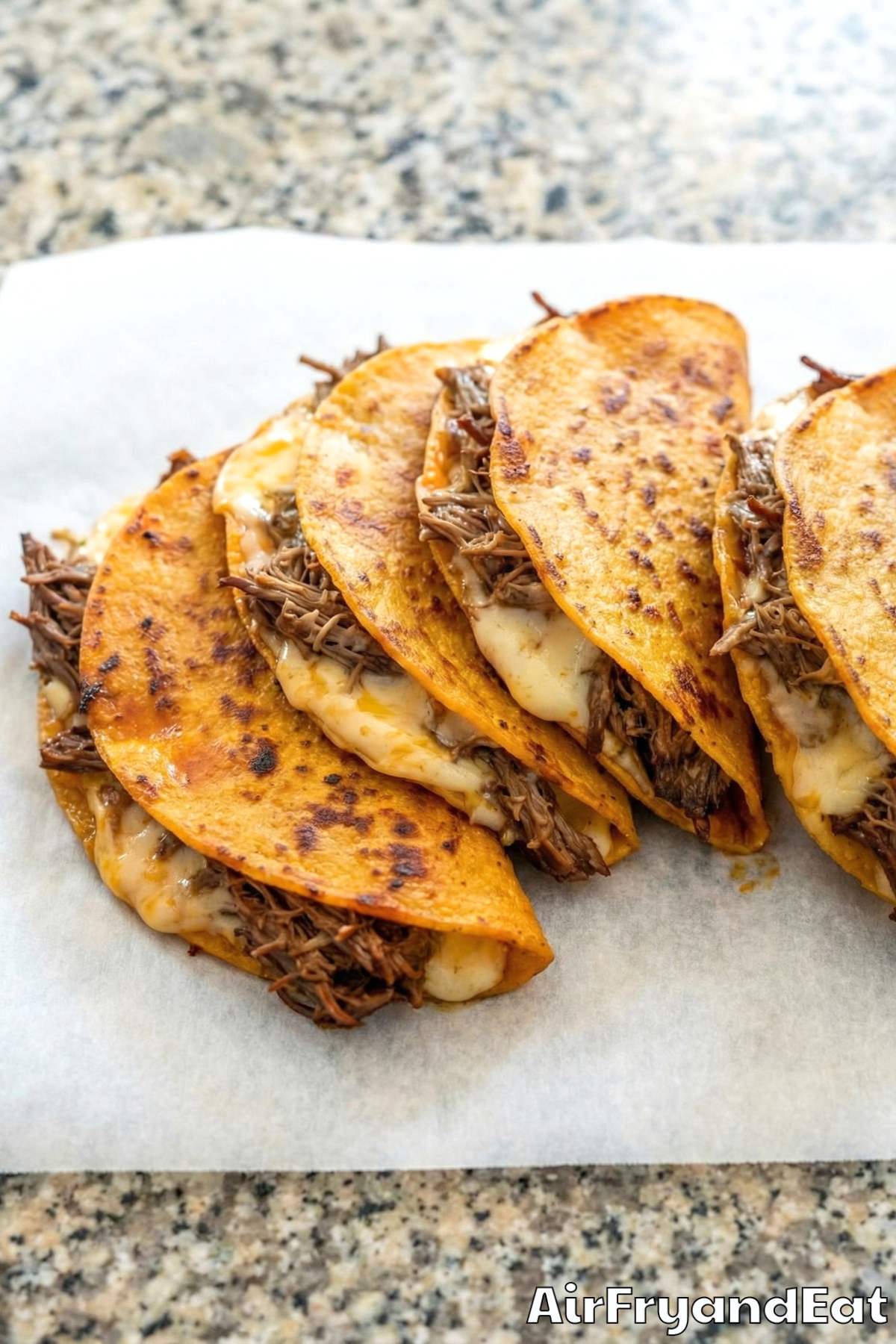 Crunchy air fryer birria tacos on a board