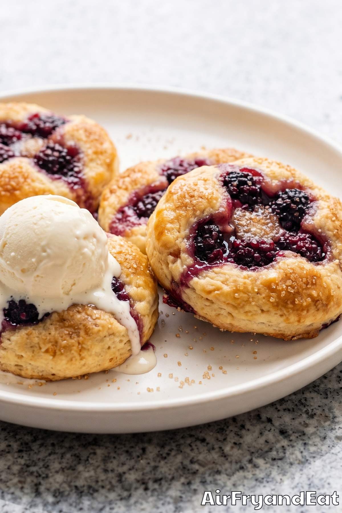 Air fryer blackberry cobbler biscuits on a plate
