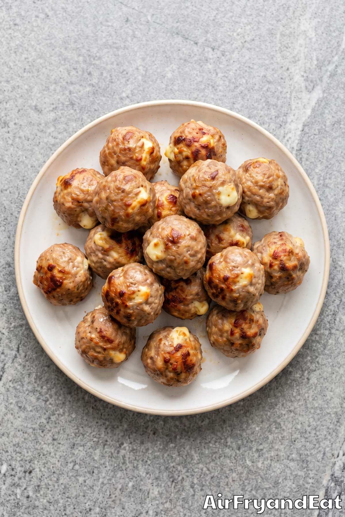Air fryer meatballs oozing with cheese