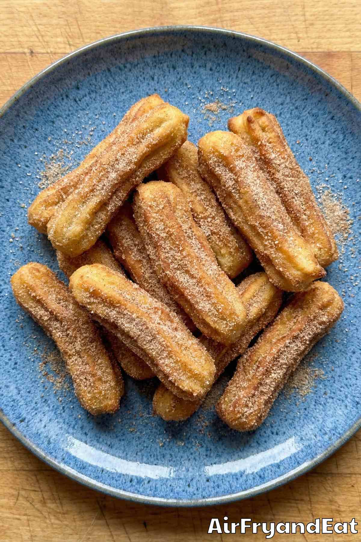 Sweet air fryer churros piled on a tray