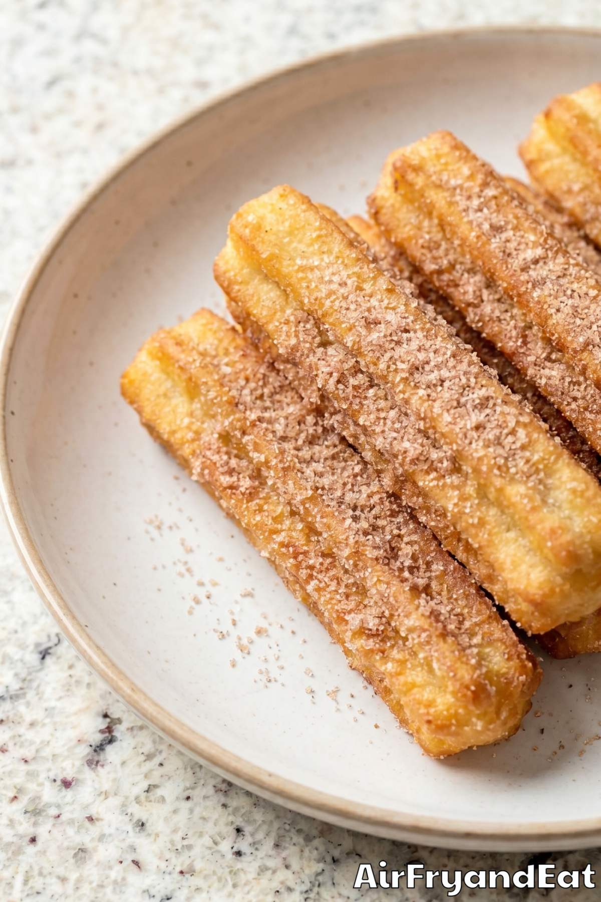 easy air fryer churros on a plate