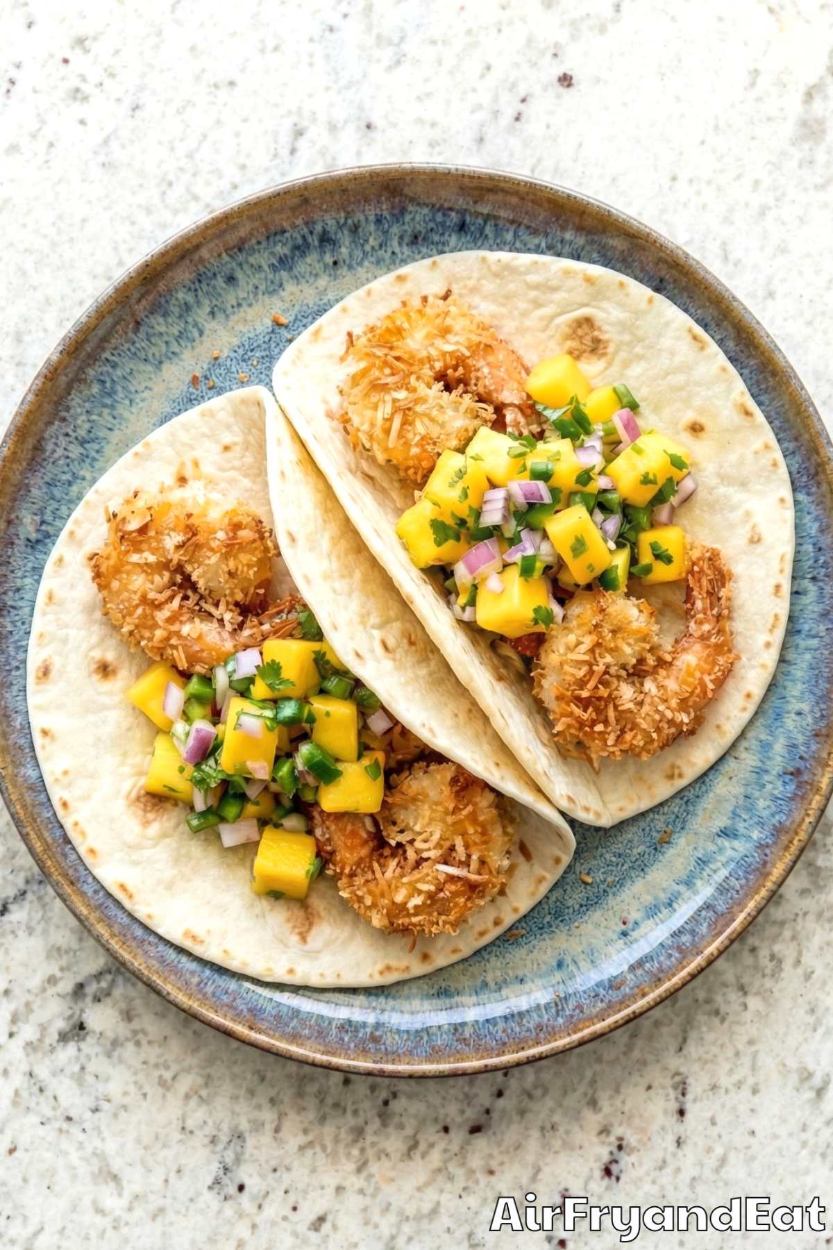 Crunchy air fryer coconut shrimp tacos served