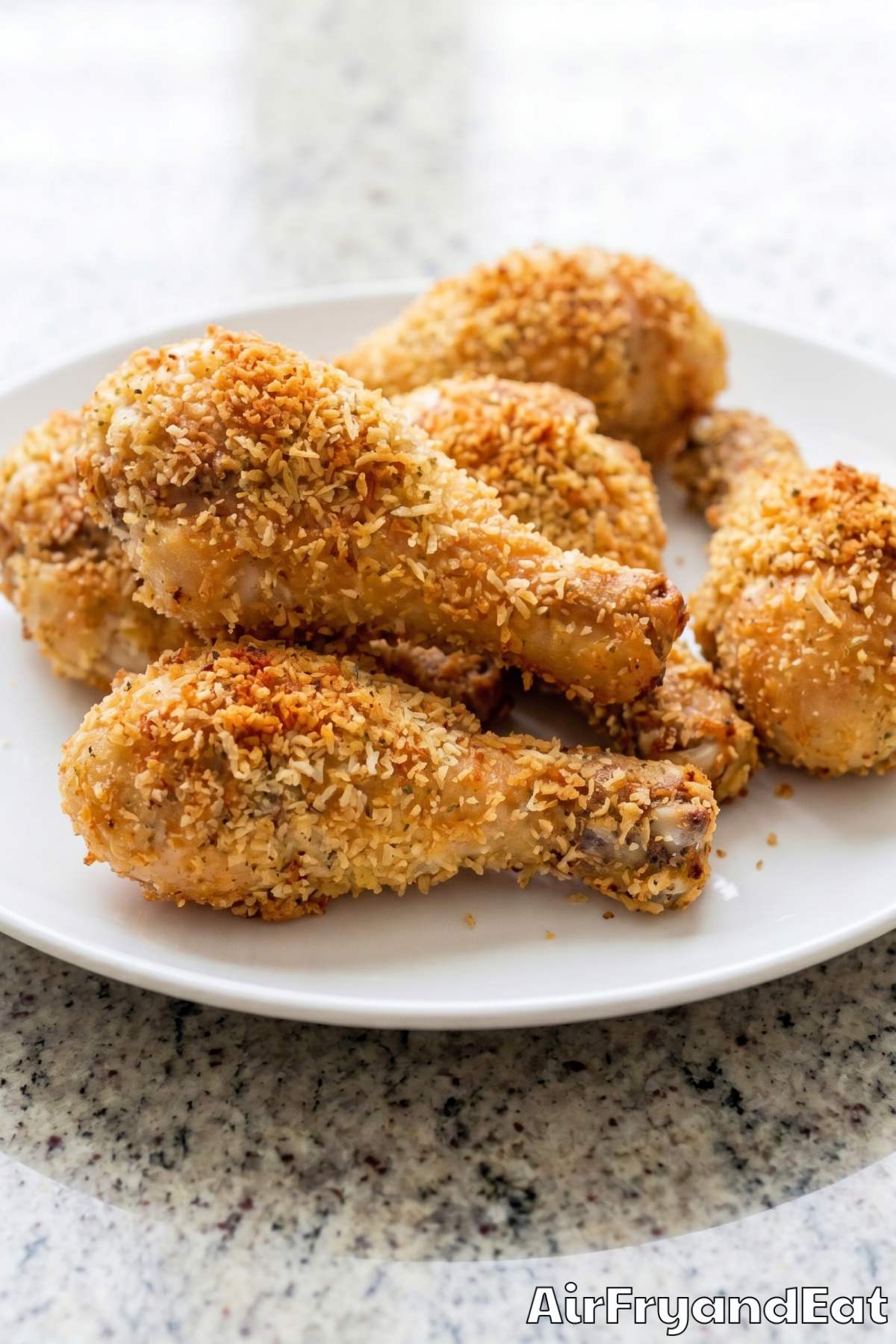 savory parmesan crusted drumsticks on plate