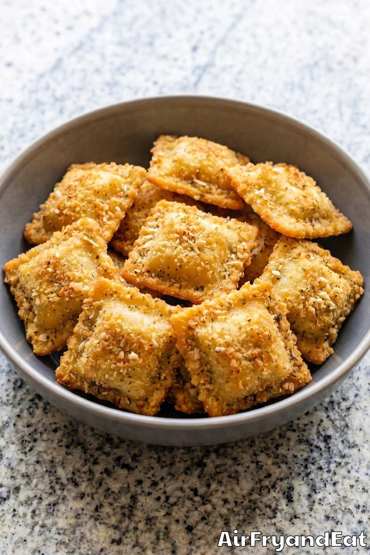 golden air fryer ravioli on a plate