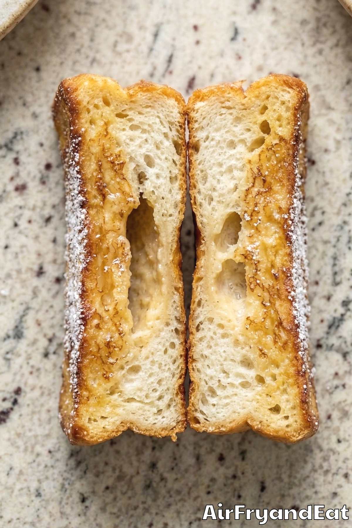 Fluffy air fryer French toast sticks on a tray