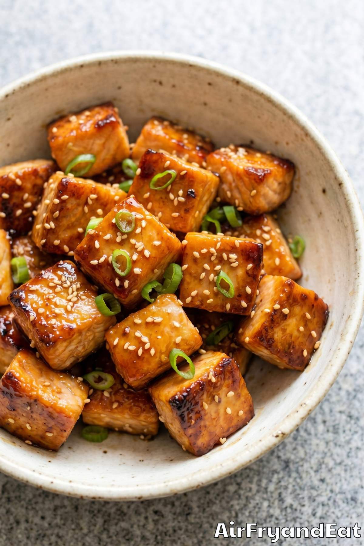 Honey garlic glazed salmon bites on a plate
