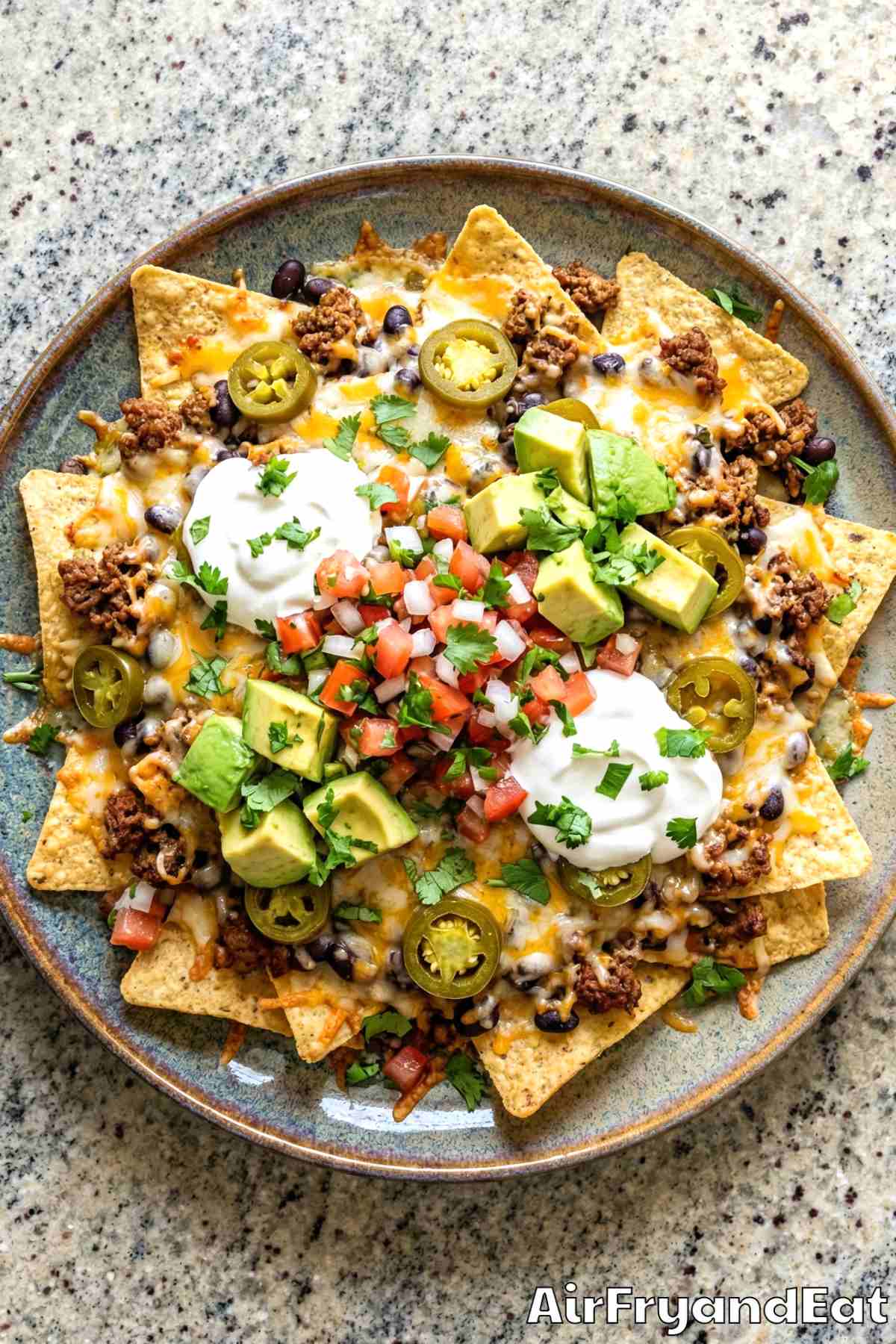 Savory air fryer loaded nachos with melted cheese