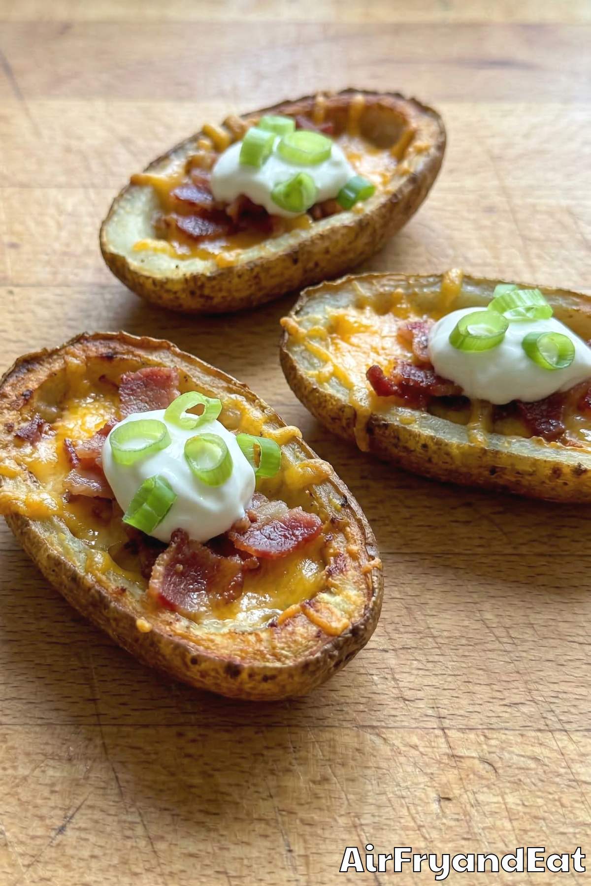 Cheesy air fryer loaded potato skins on a platter
