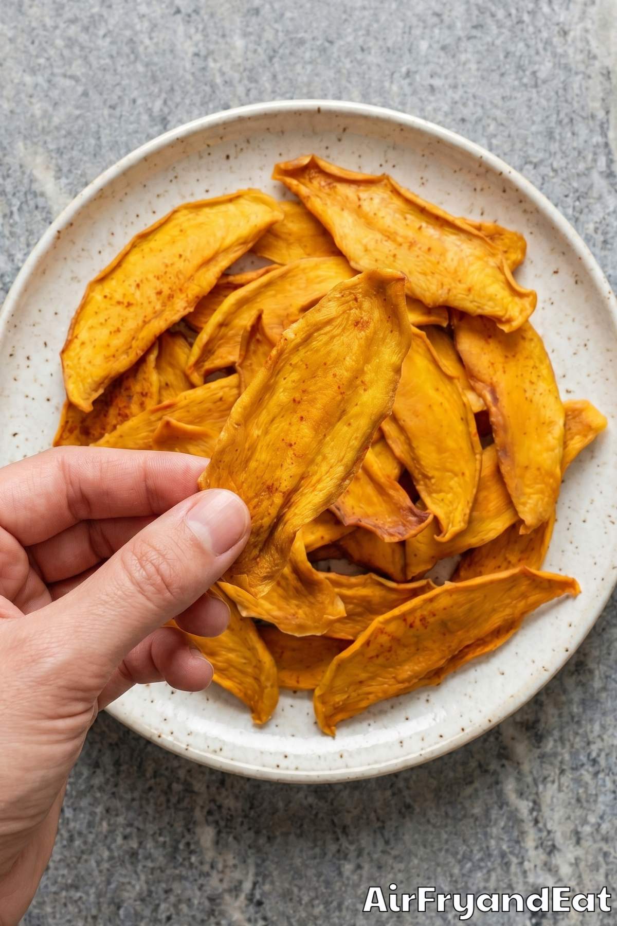 Thin mango strips dehydrating in air fryer